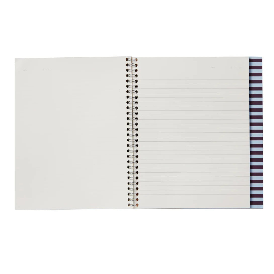 An open spiral-bound notebook with lined pages, photographed against a plain white background.