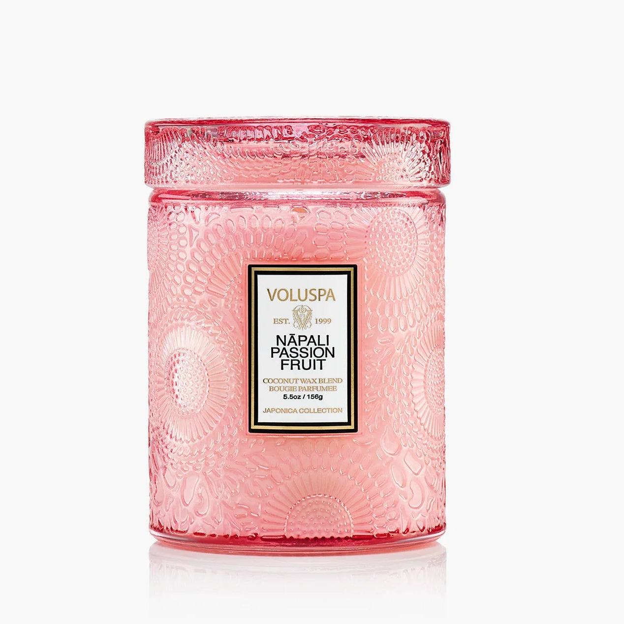 Pink Voluspa candle with a label on a white background