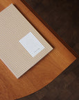 Notebook with a striped cover on a wooden surface