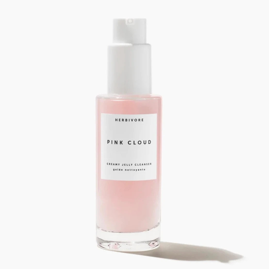 glass bottle with pink cleanser inside 