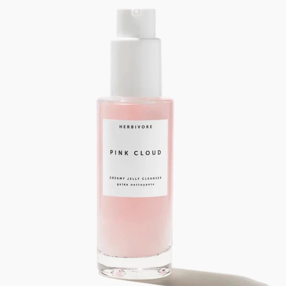 glass bottle with pink cleanser inside 