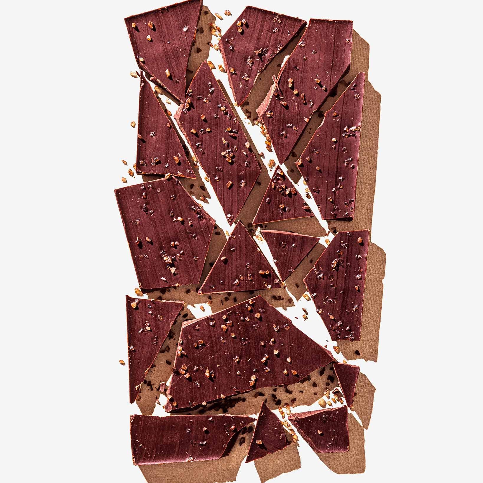 Broken chocolate bar pieces on a white background