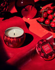 round red tin candle with red background