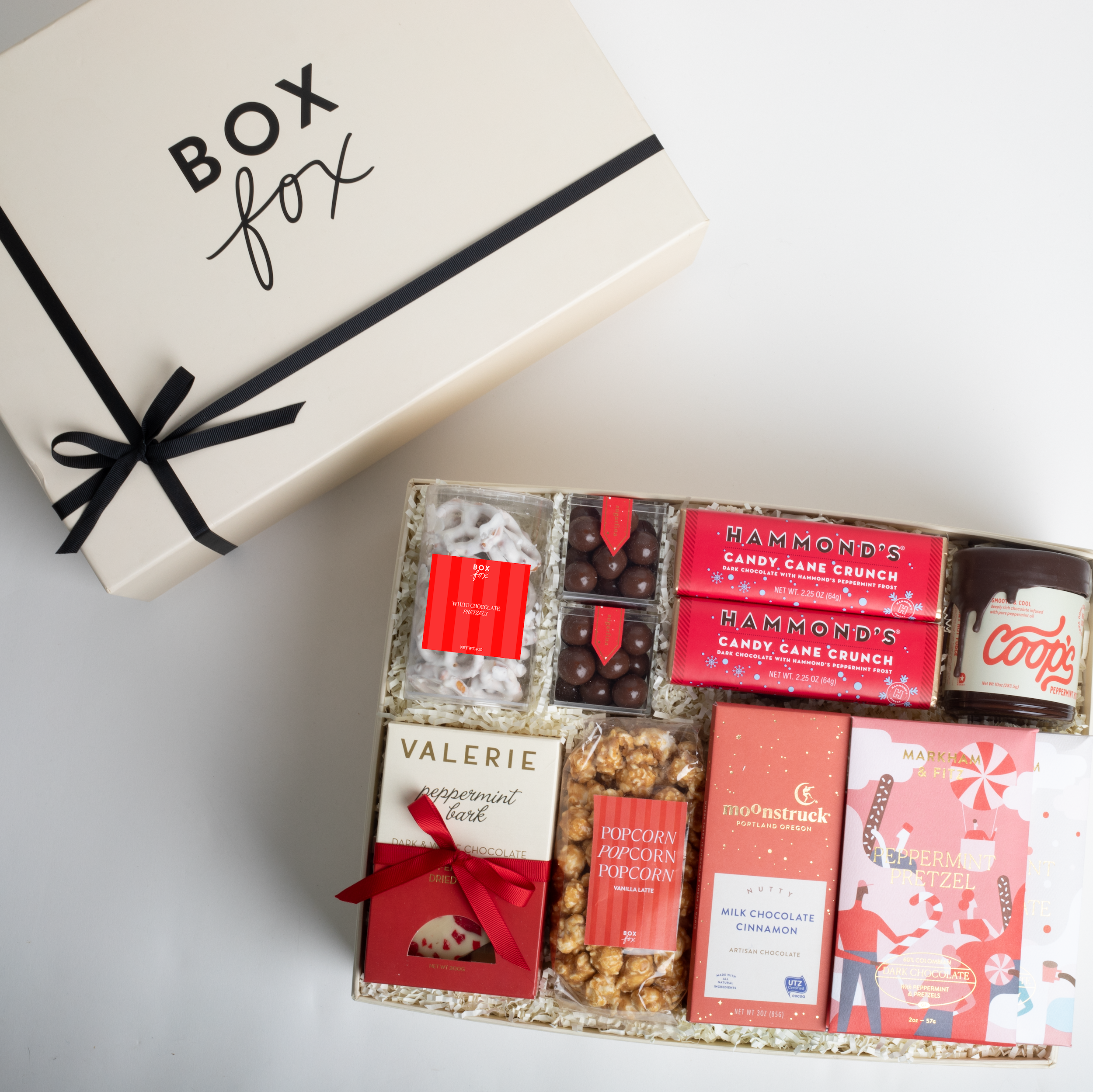 Gift box with various confectioneries and a branded box labeled 'Box Fox' on a light background.