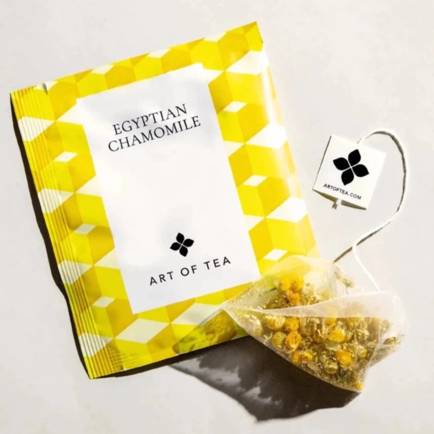 yellow and white tea bag and tea sachet on a neutral background