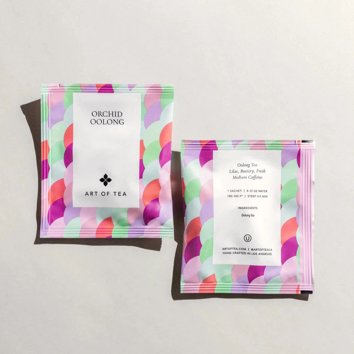 pastel colored tea sachet with. varies hues of purple, blue & green