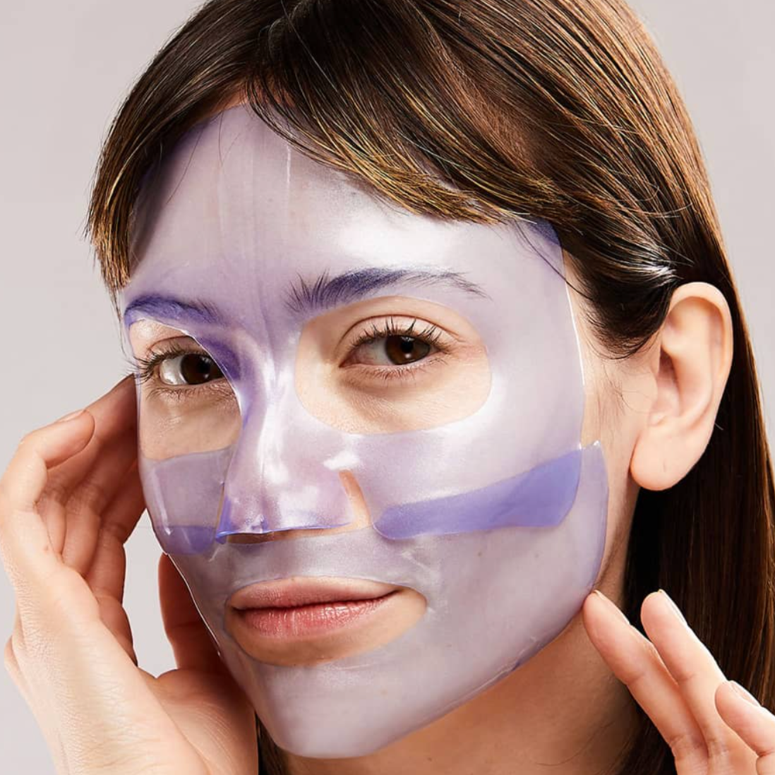 girl with brown hair with purple gel mask on
