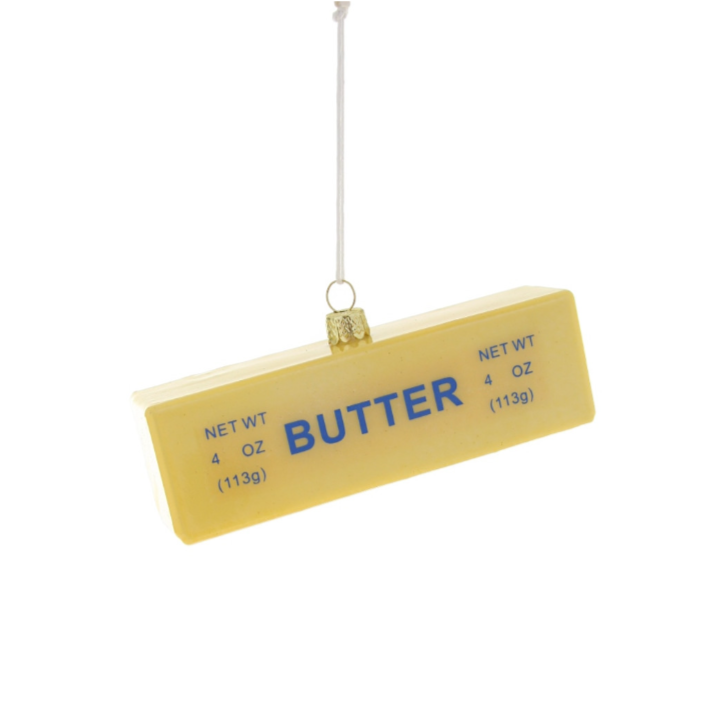 Stick of butter ornament hanging on white background