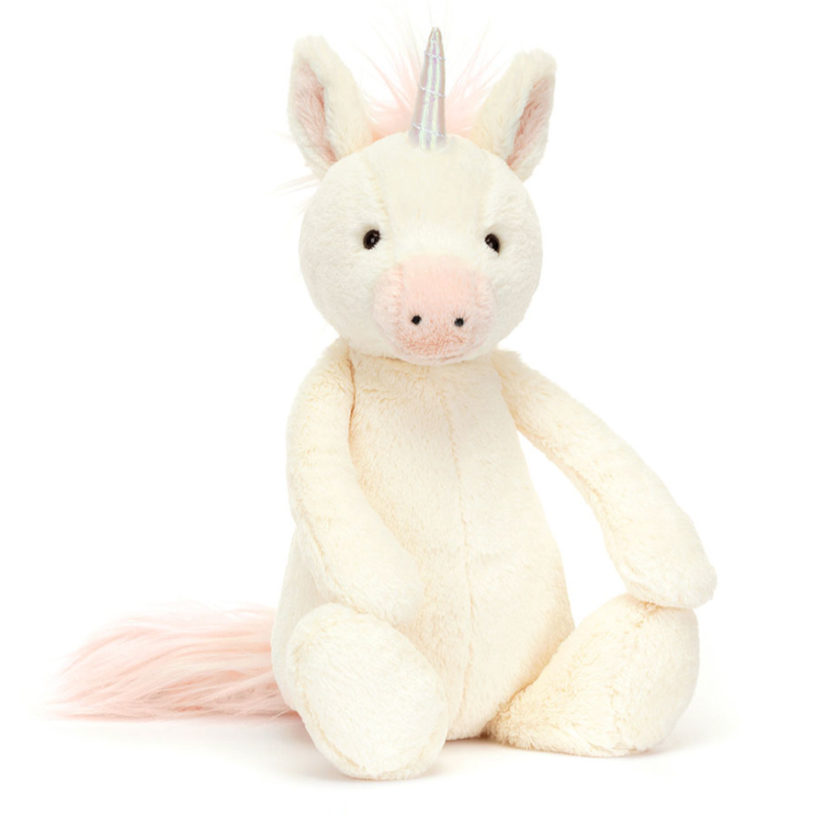 Pink and white unicorn is front facing on a white background