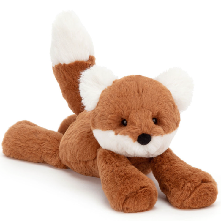 A orange and white fox stuffed animal front facing, laying down