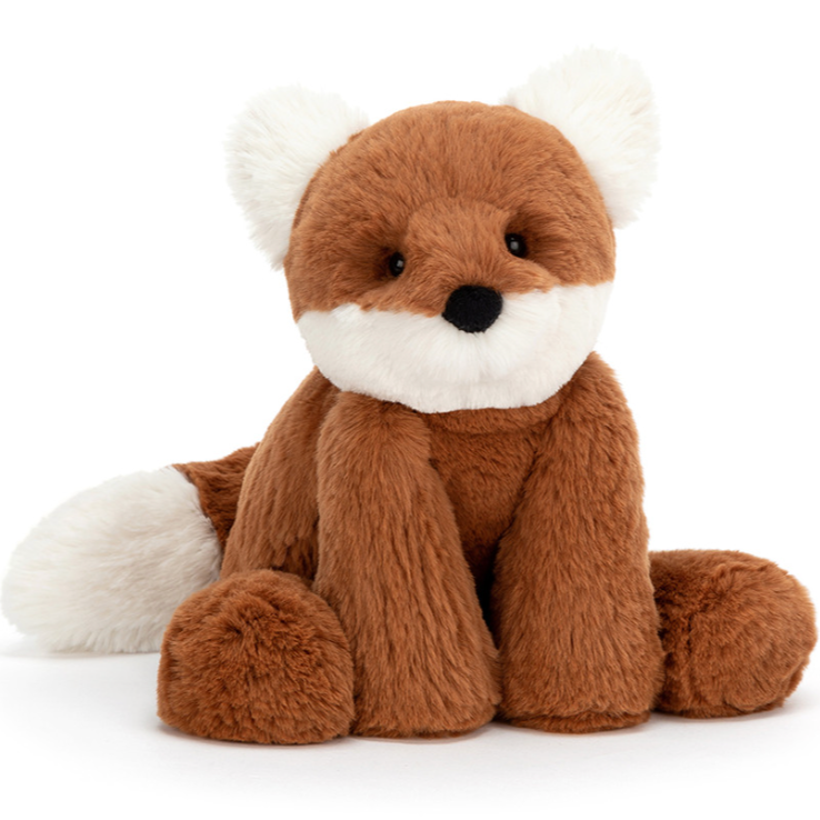 A orange and white fox stuffed animal front facing, sitting down