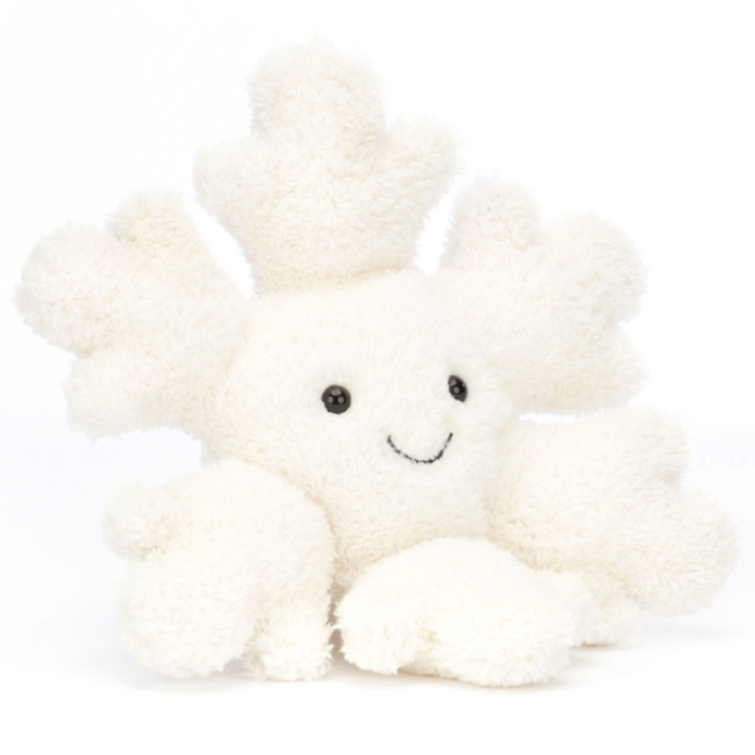 A snowflake stuffed animal sitting down front facing on a white background