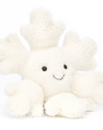 A snowflake stuffed animal sitting down front facing on a white background