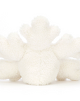 A snowflake stuffed animal sitting down back facing on a white background