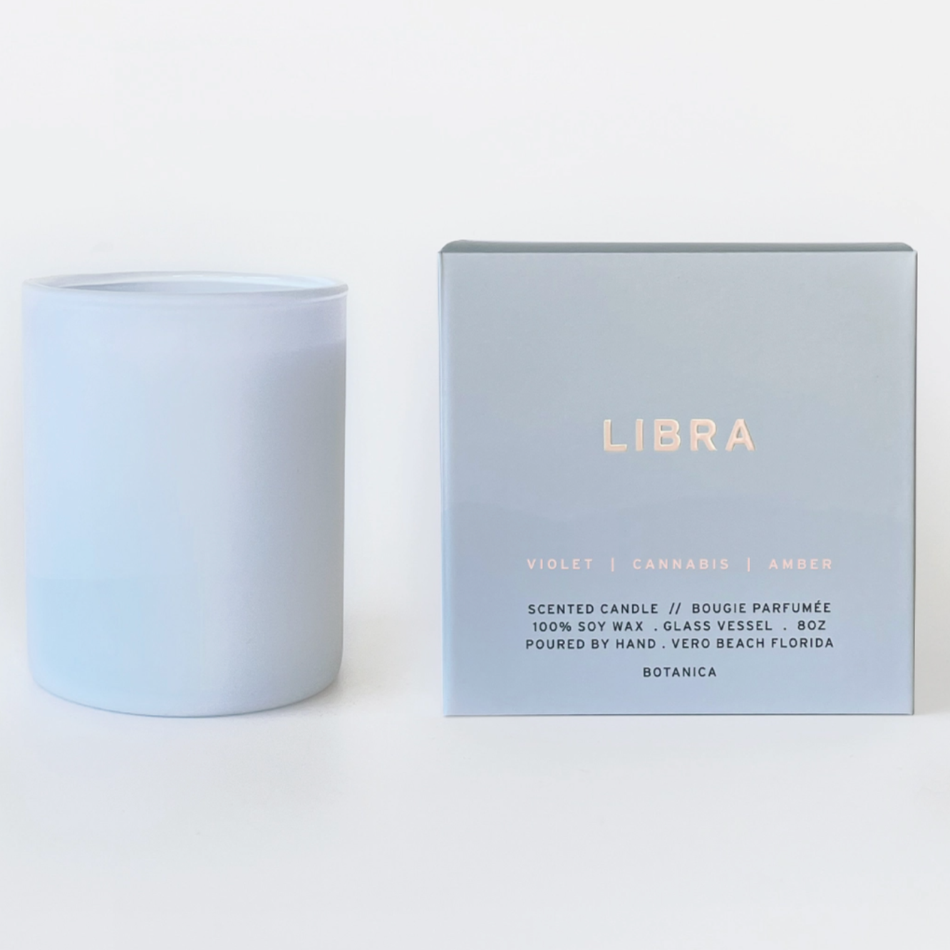 light blue candle that says libra behind white background