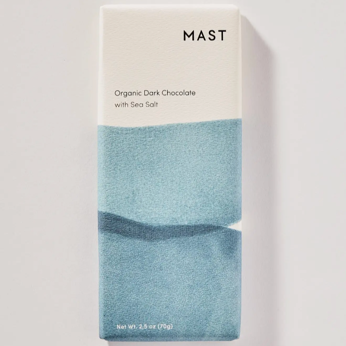 A chocolate bar in blue and white packaging on a white background that reads, "MAST Organic Dark Chocolate with Sea Salt"