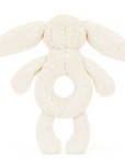 cream-colored bunny facing background with toy soft, fluffy fur. The body features a circular opening in the middle, giving it a ring-like structure