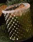 Handblown glass ornament shaped like a margarita hanging from Christmas tree 