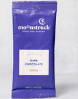 BLUE HOT CHOCOLATE PACKET THAT READS "MOONSTRUCK DREAMY DARK CHOCOLATE COCOA"