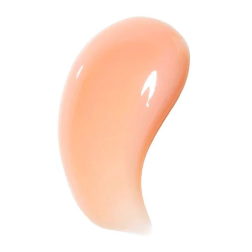 A glossy, peach-tinted swatch of the lip mask, showing a smooth, shiny texture intended to illustrate the product's consistency.