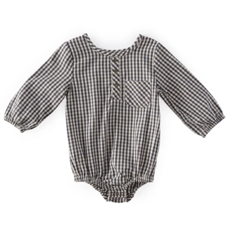 A long-sleeved baby romper made from black-and-white gingham fabric, featuring a front button placket, a small chest pocket, and elasticated leg openings for a comfortable fit.