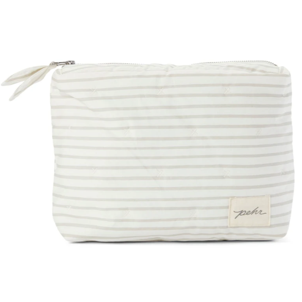 A soft, zippered pouch with light gray and white horizontal stripes, featuring subtle stitched accents. The pouch, labeled with a small "pehr" tag on the lower right corner, has a simple bow knot detail on the zipper pull, giving it a charming and minimalist design.