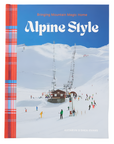 Front cover of the book "Alpine Style: Bringing Mountain Magic Home" by Kathryn O'Shea-Evans. The design features a snowy mountain scene with skiers, ski lifts, and a cozy alpine building. A bold plaid spine in red, blue, and white adds a touch of warmth to the design. The title suggests the book explores ways to incorporate alpine-inspired aesthetics into everyday living.