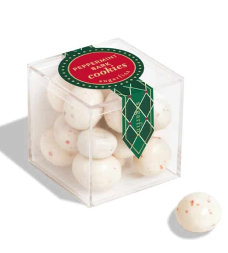 clear candy cube filled with white peppermint balls with specks of red