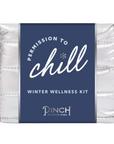 small metallic pouch with navy label that says PERMISSION TO CHILL WINTER WELLNESS KIT 