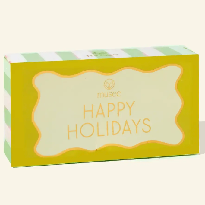 HAPPY HOLIDAYS SOAP BY MUSEE WITH YELLOW AND GREEN AND WHITE STRIPED PACKAGING