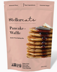 STELLAR EATS PANCAKE AND WAFFLE KIT WITH PICTURE OF PANCAKES WITH SYRUP ON THE FRONT. ALMOND FLOUR AND COCONUT SUGAR, ON PINK PACKAGING