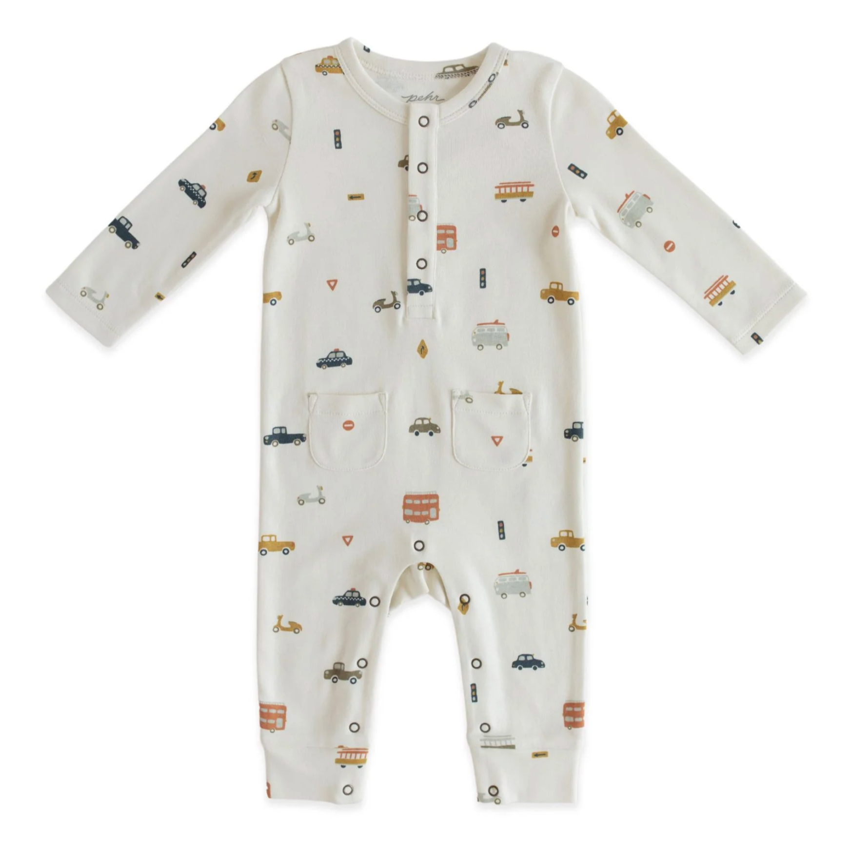 A white baby romper with multicolor car, bus and scooter print all over, metal snaps at collar and two pockets at hips. Photographed on white background.