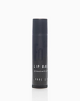 A stick of lip balm with a black twist-up tube, labeled with the product name and an indication of protective and nourishing properties.