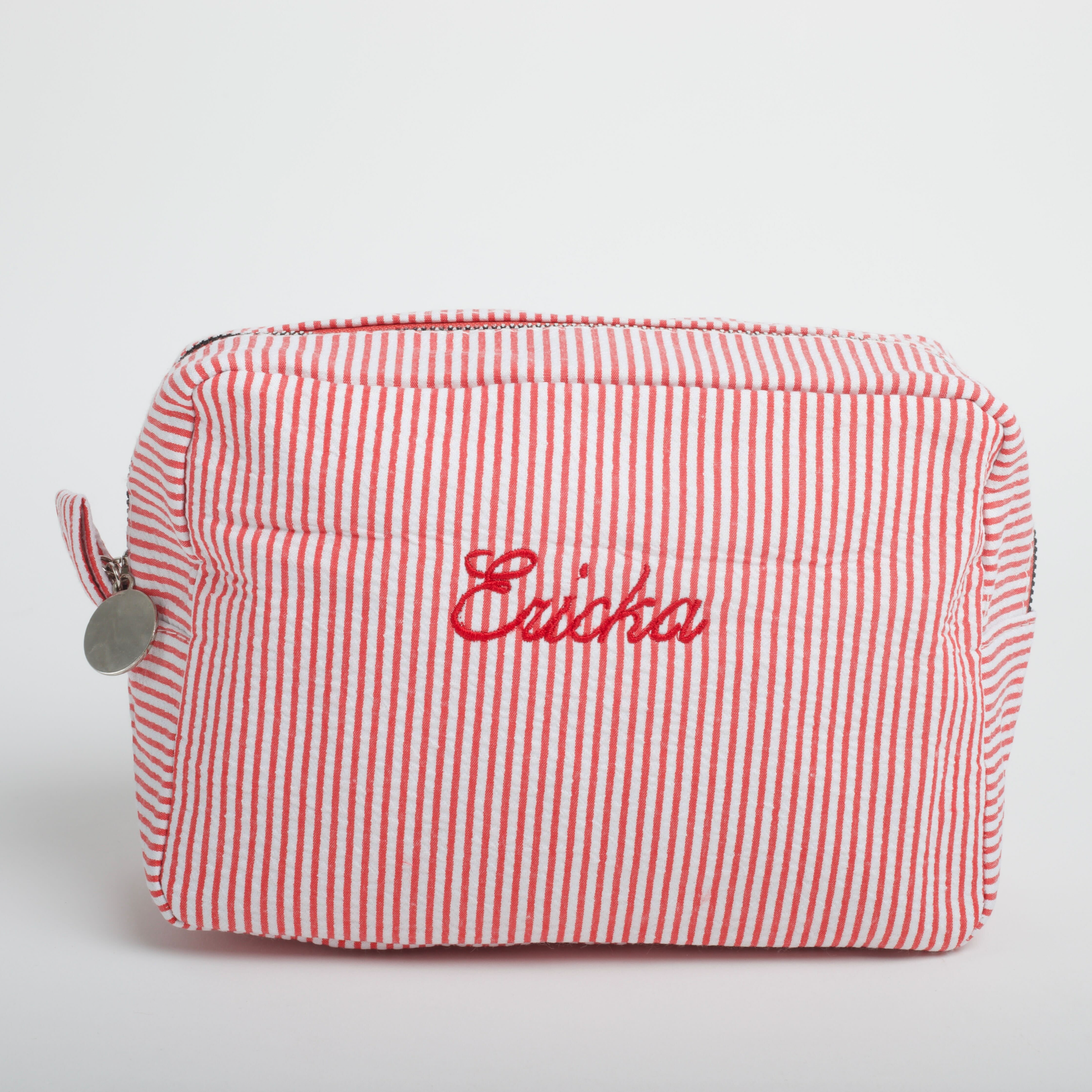 bright red & white striped makeup bag embroidered in red with the name 'Ericka'