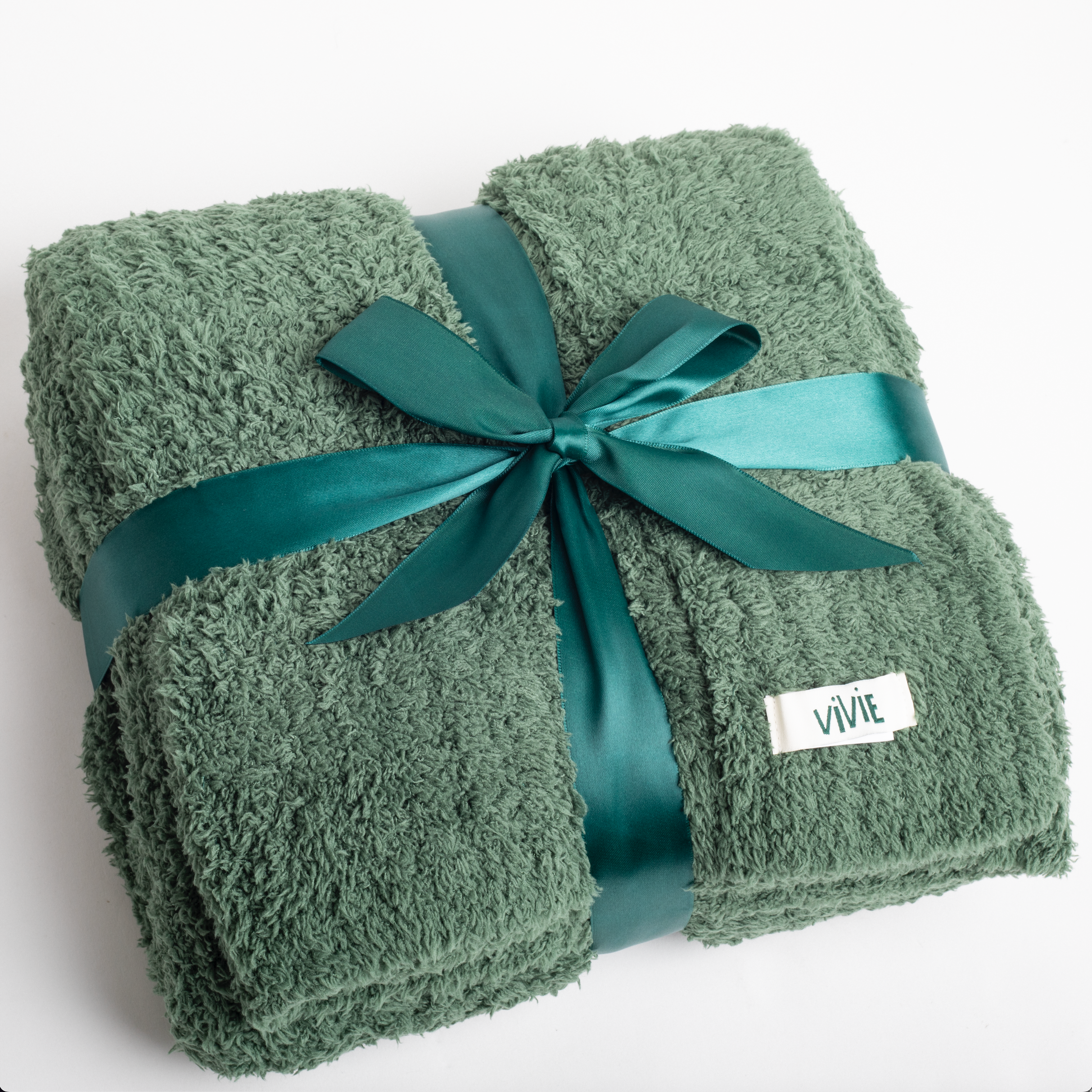 Green towel with a teal ribbon and 'VIVIE' label on a white background