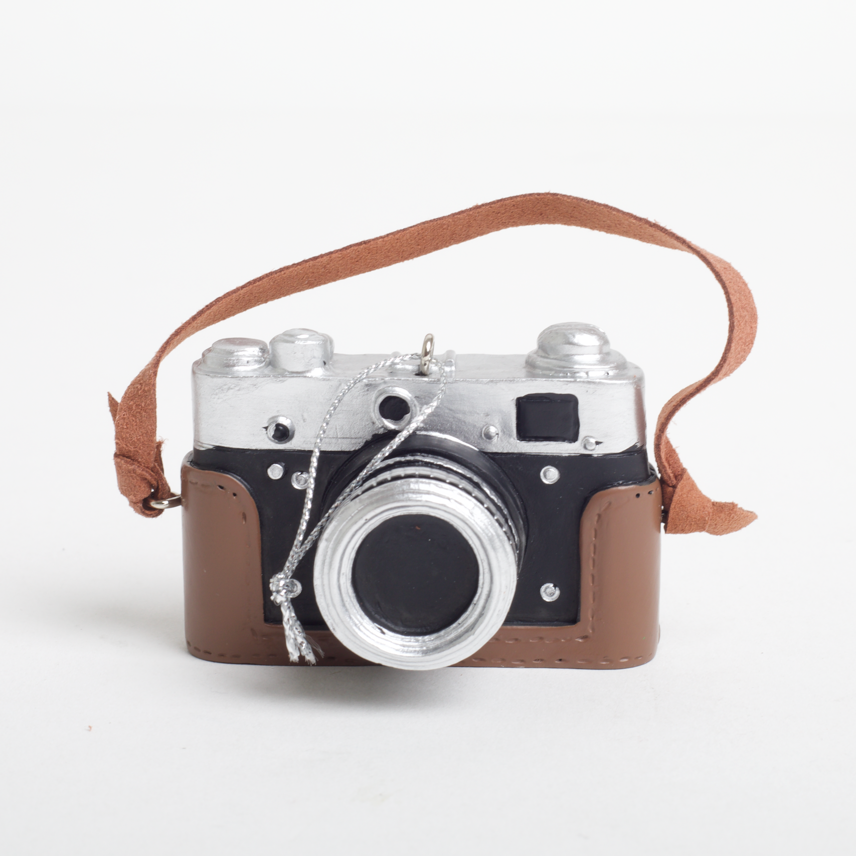 Vintage camera with a brown strap on a white background