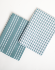 Two blue checkered fabric swatches on a white background