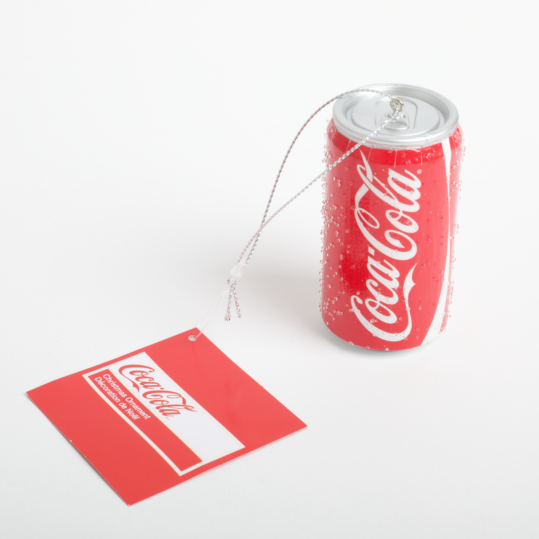 Coca-Cola tea bag and can on a white background