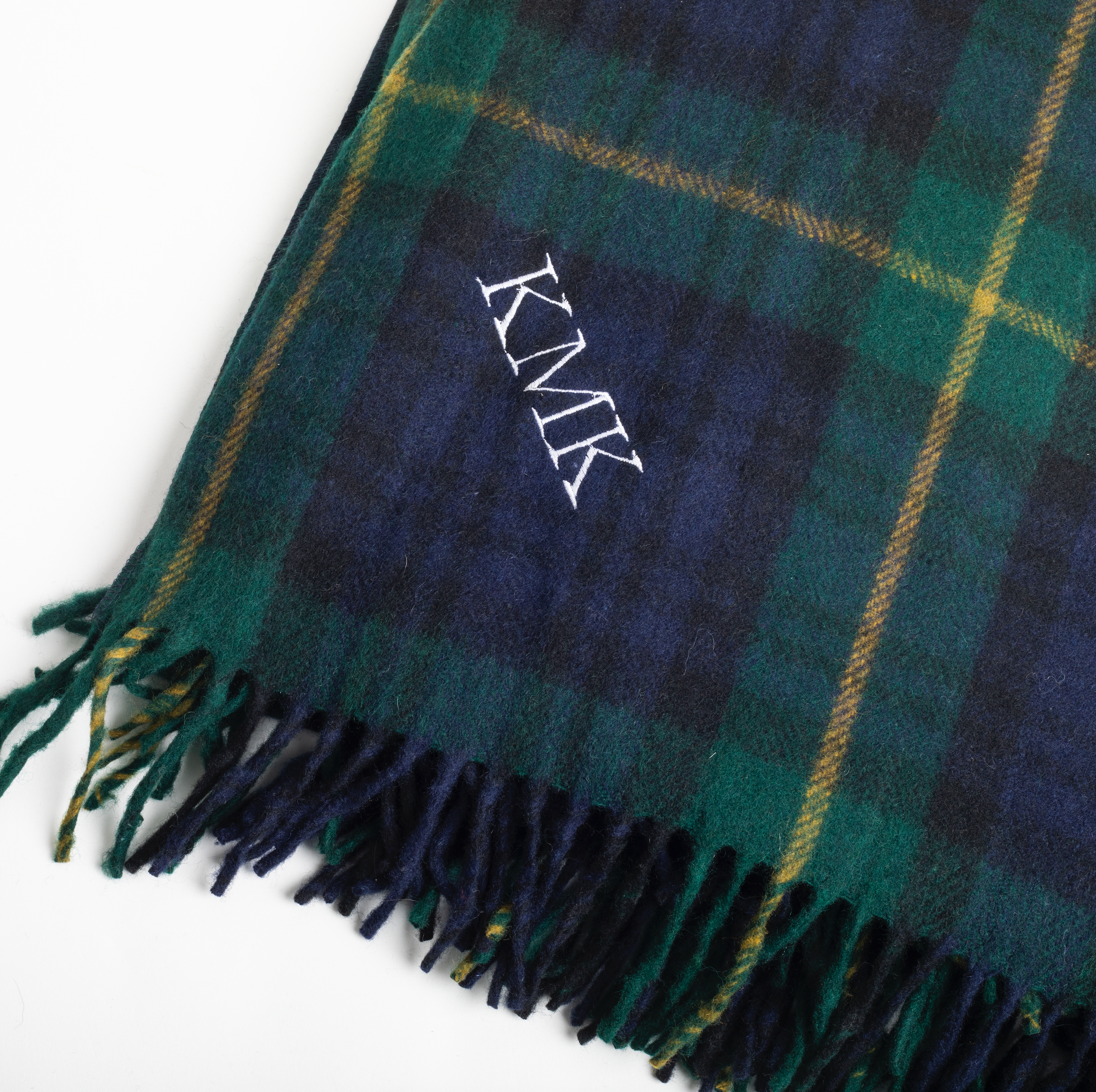 Plaid scarf with monogram 'KMK' on a white background