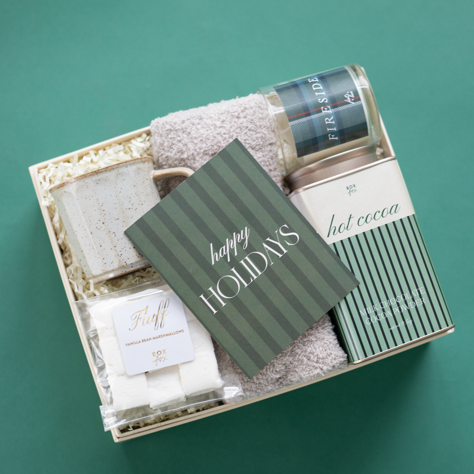 Gift set with bath products and a card on a green background