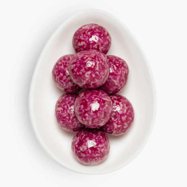Pink marbled candies on a white plate with a white background