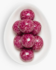Pink marbled candies on a white plate with a white background