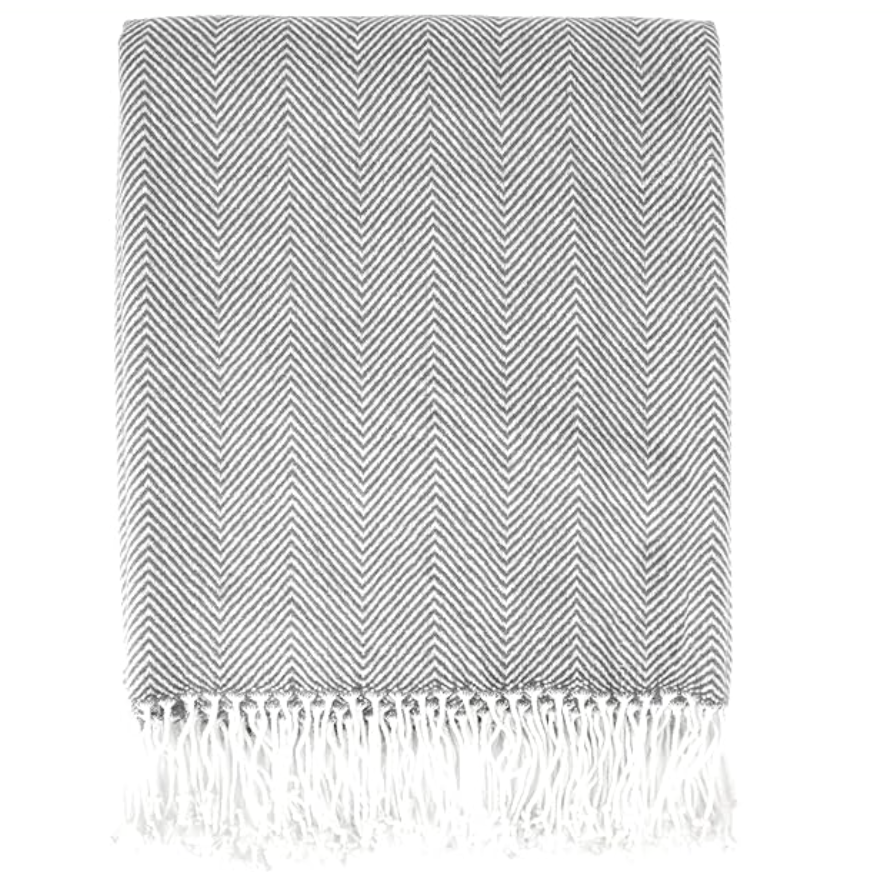 Gray and white striped blanket with fringes on a white background
