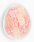 Gummy bears in a white bowl on a white background