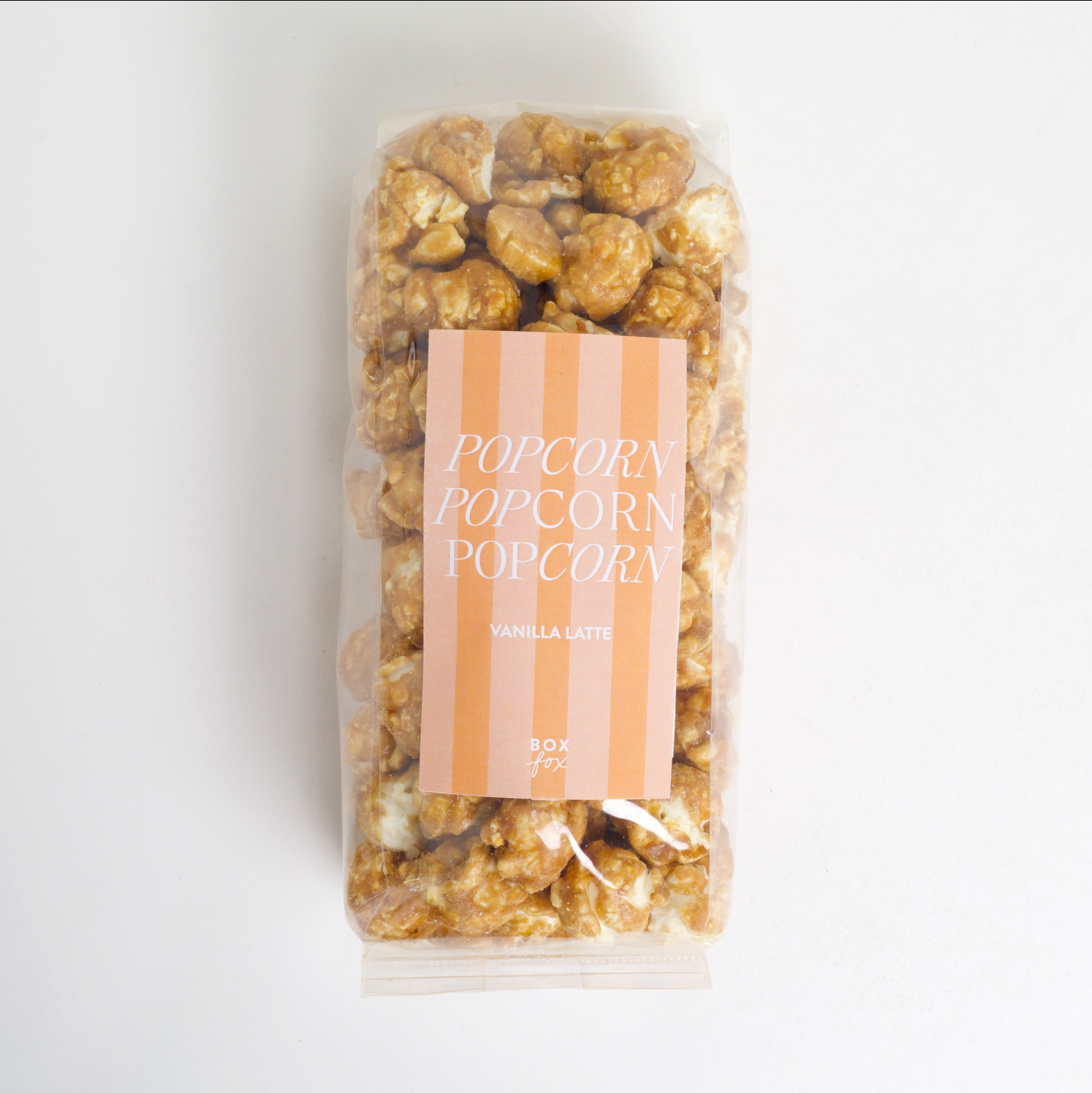 Packaged popcorn with a striped label on a light background