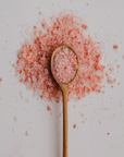 Spoon with pink Himalayan salt on a light background