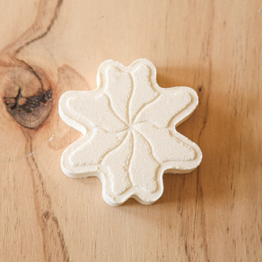 Flower-shaped bath bomb on a wooden surface