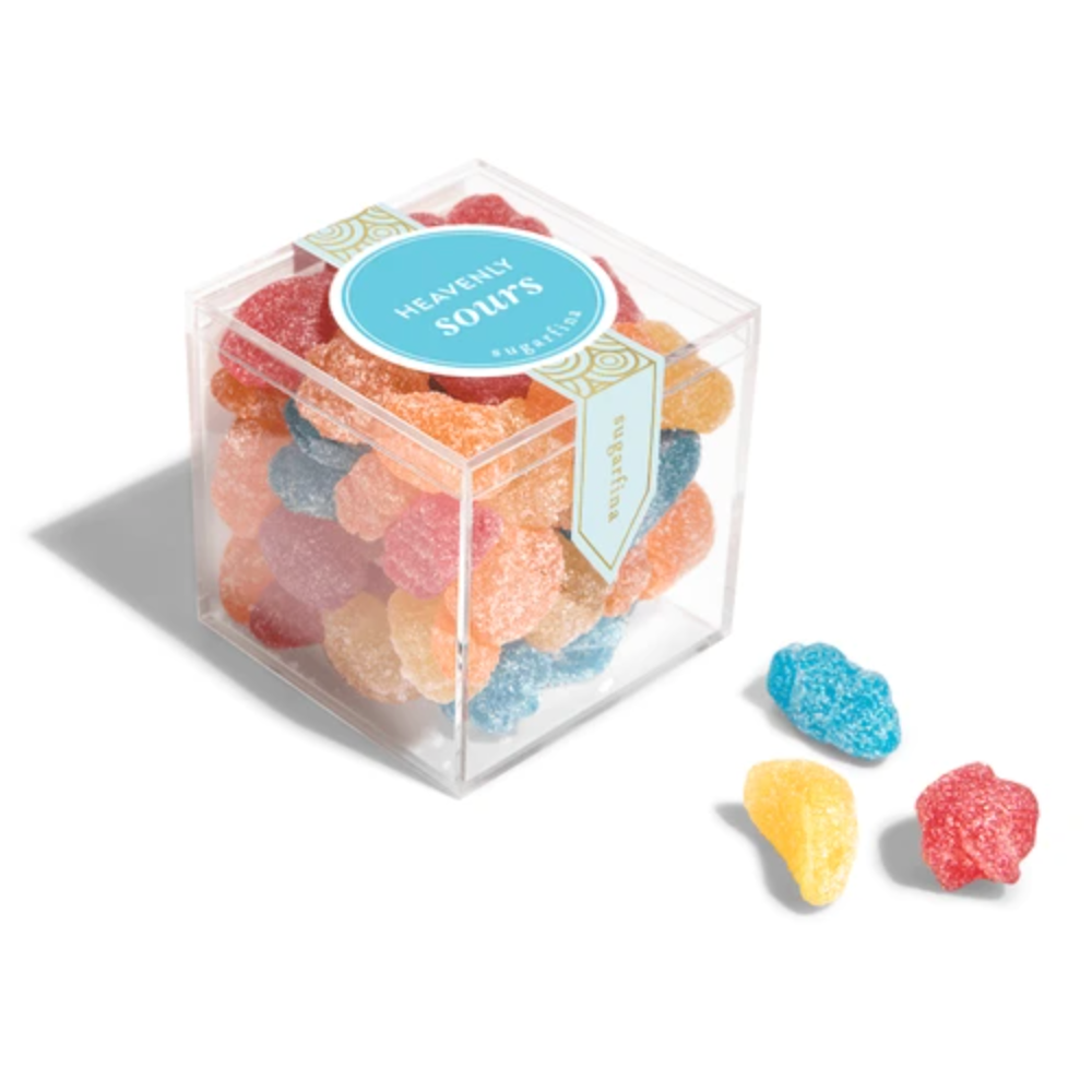 Clear cube container filled with colorful gummy candies labeled 'Heavenly Sours' on a white background.