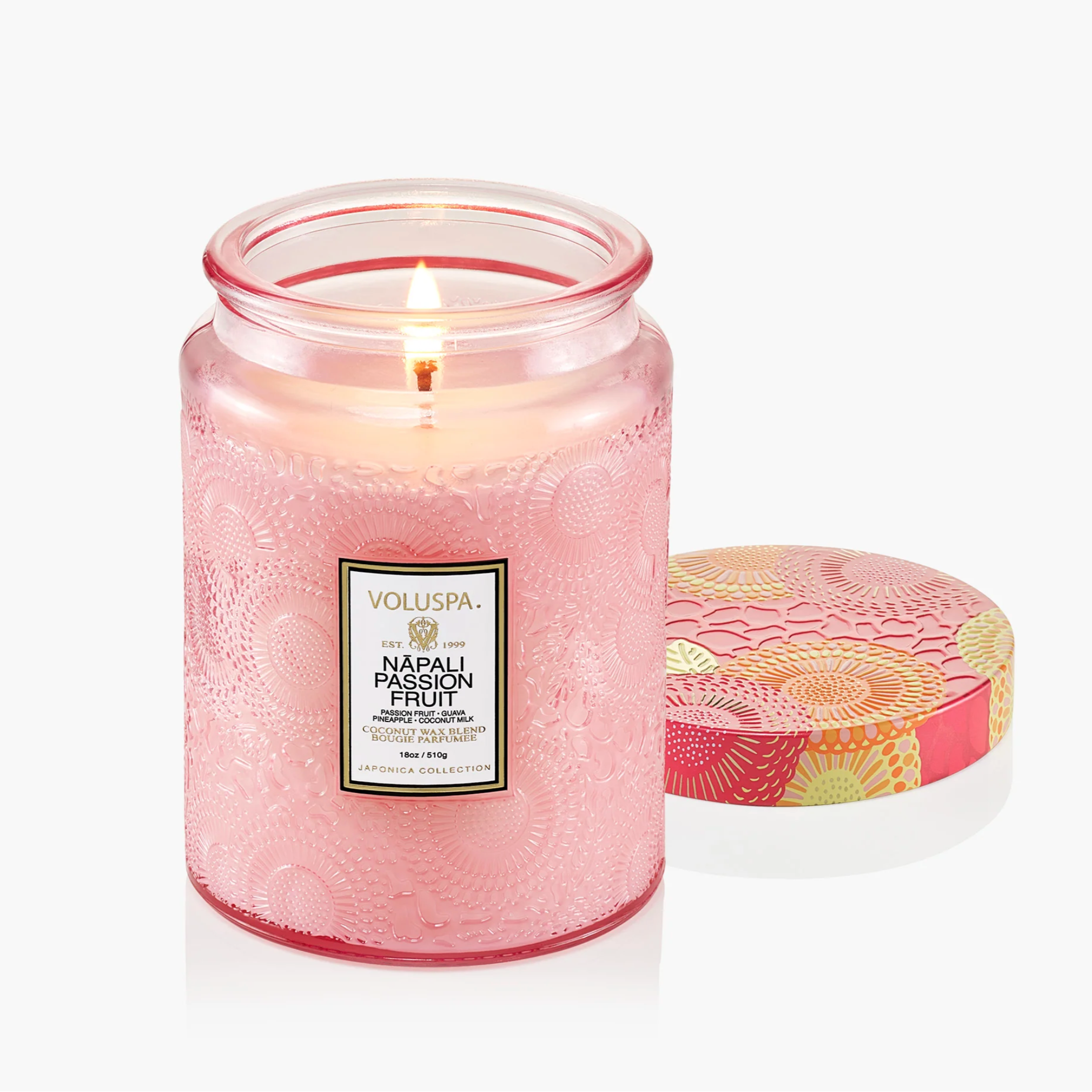 Pink candle with a Voluspa label on a white background