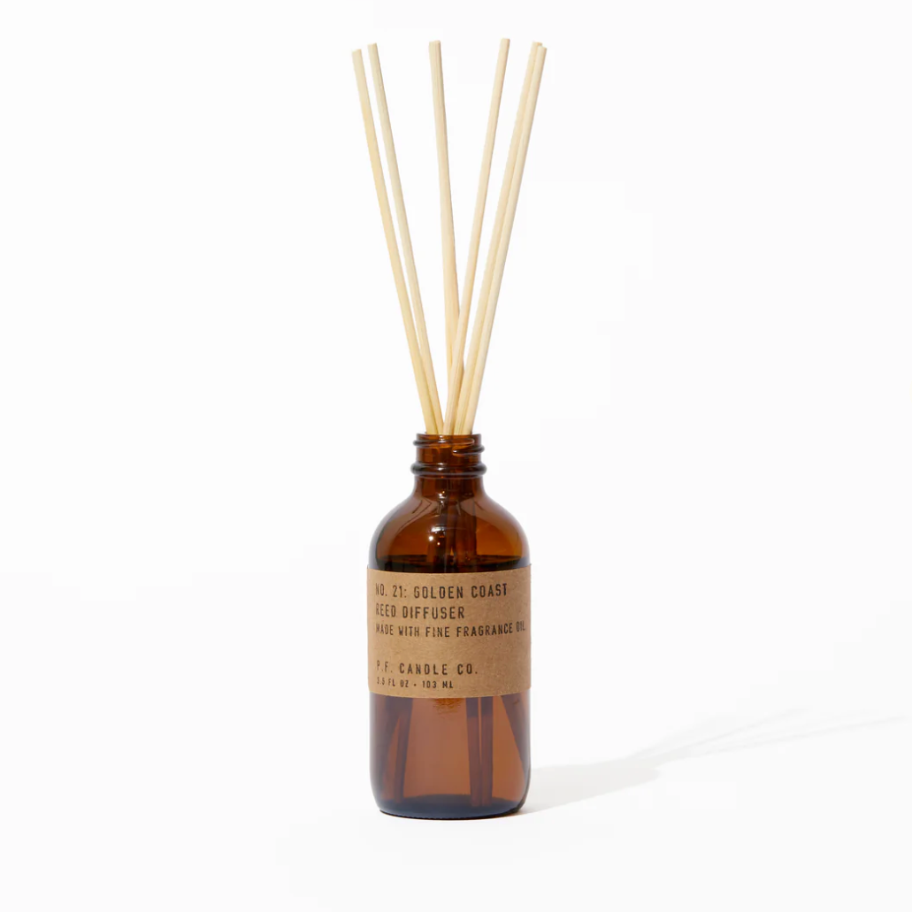 Brown glass diffuser bottle with wooden sticks on a white background